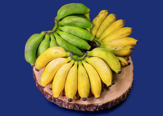 Apple Bananas on wooden slab