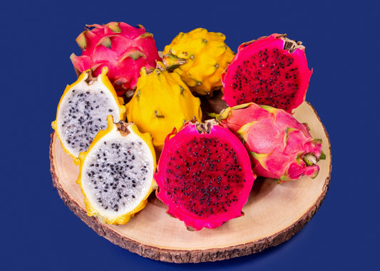 Dragon fruits on a wooden board with a blue background