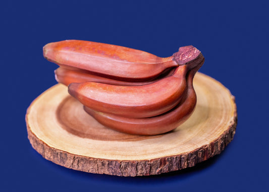 Red Bananas on a wooden slab