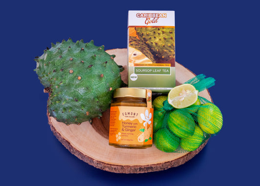 Soursop. Tea, Honey & Key Limes on a wooden slab.